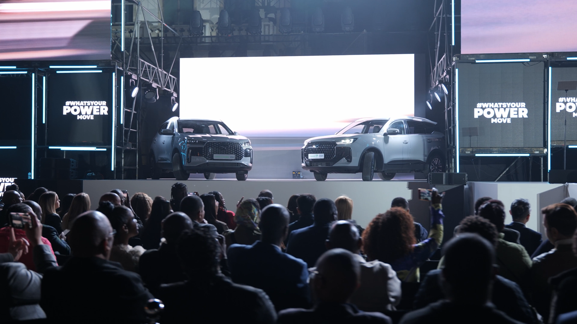 Mushroom Motion live event production — two vehicles revealed on stage to a seated audience at a large-scale brand launch event in South Africa